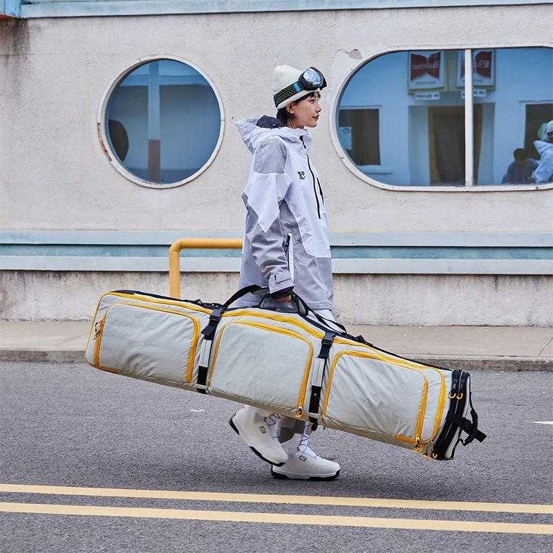 Adjustable snowboard equipment carrier with handles